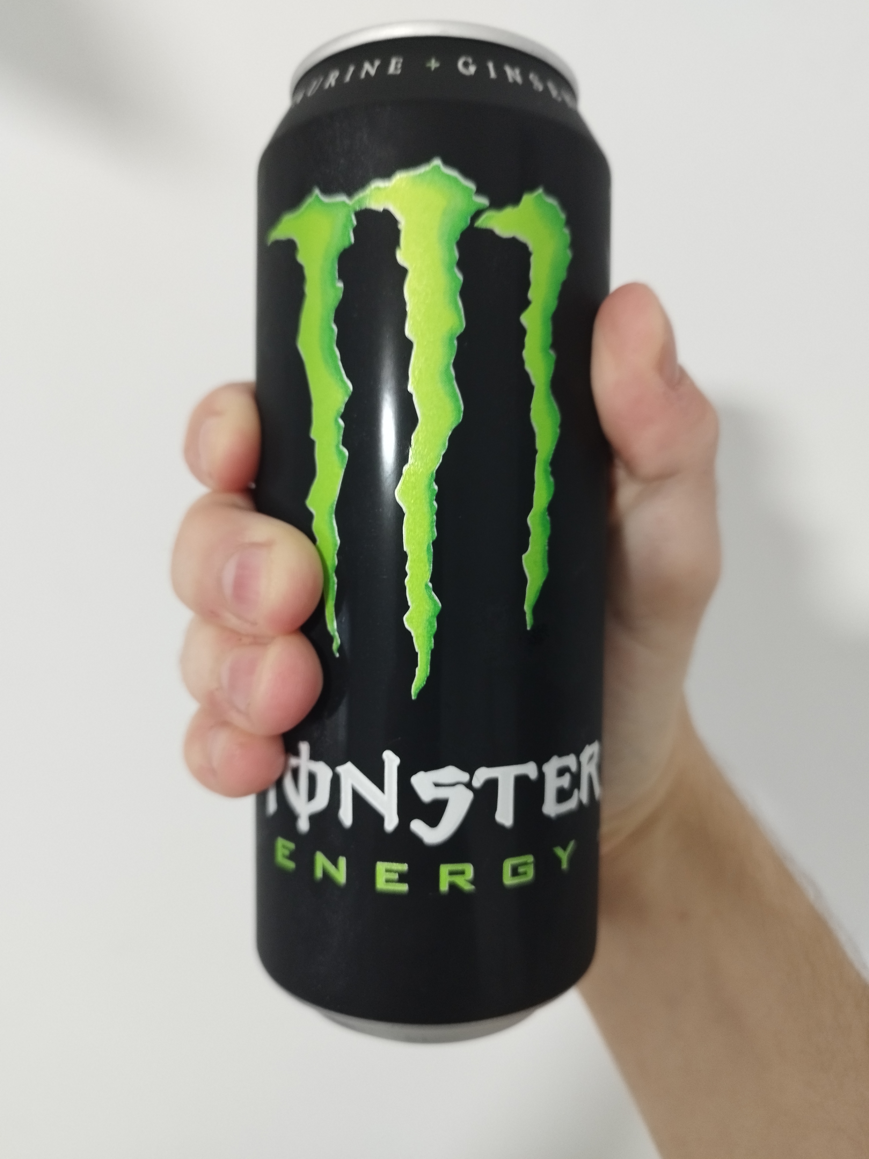 a black can of original green monster energy with a green M logomark