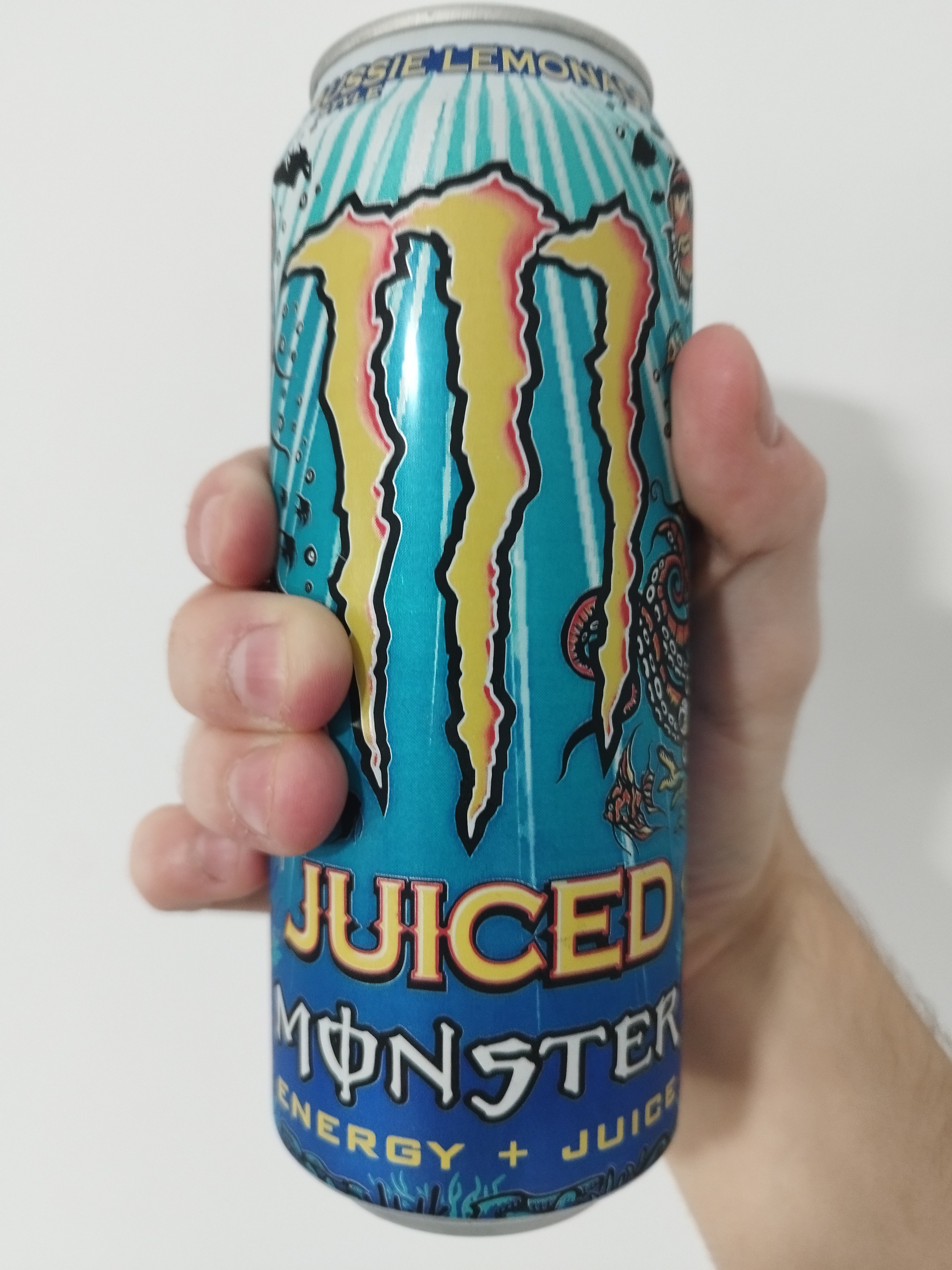 a blue coloured juiced monster aussie lemonade. on the can are illustrations of various sealife.